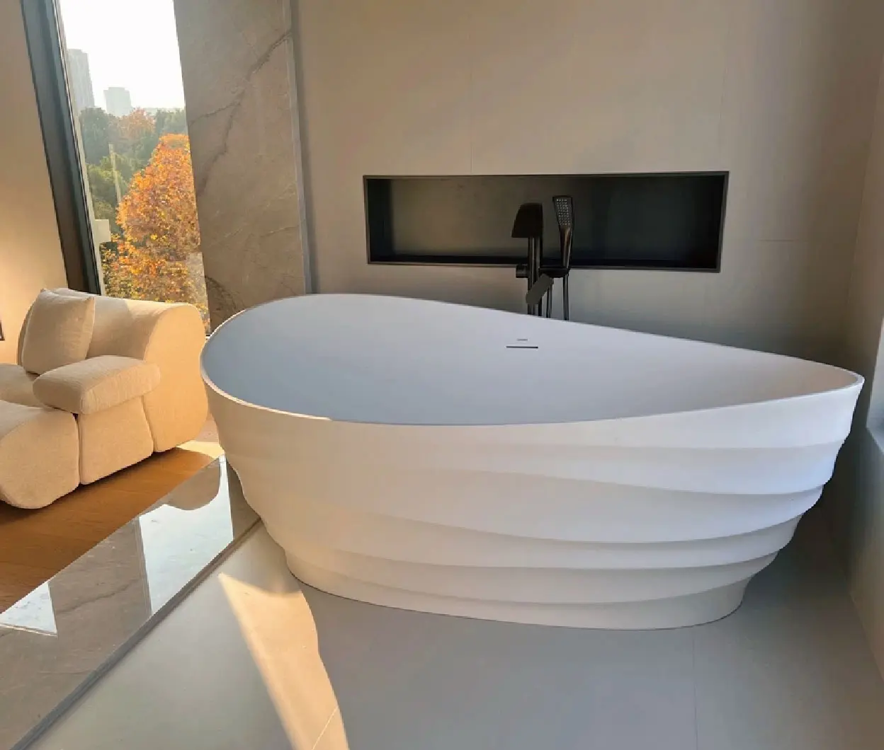 CloudRipple bathtub installed beside a city view window