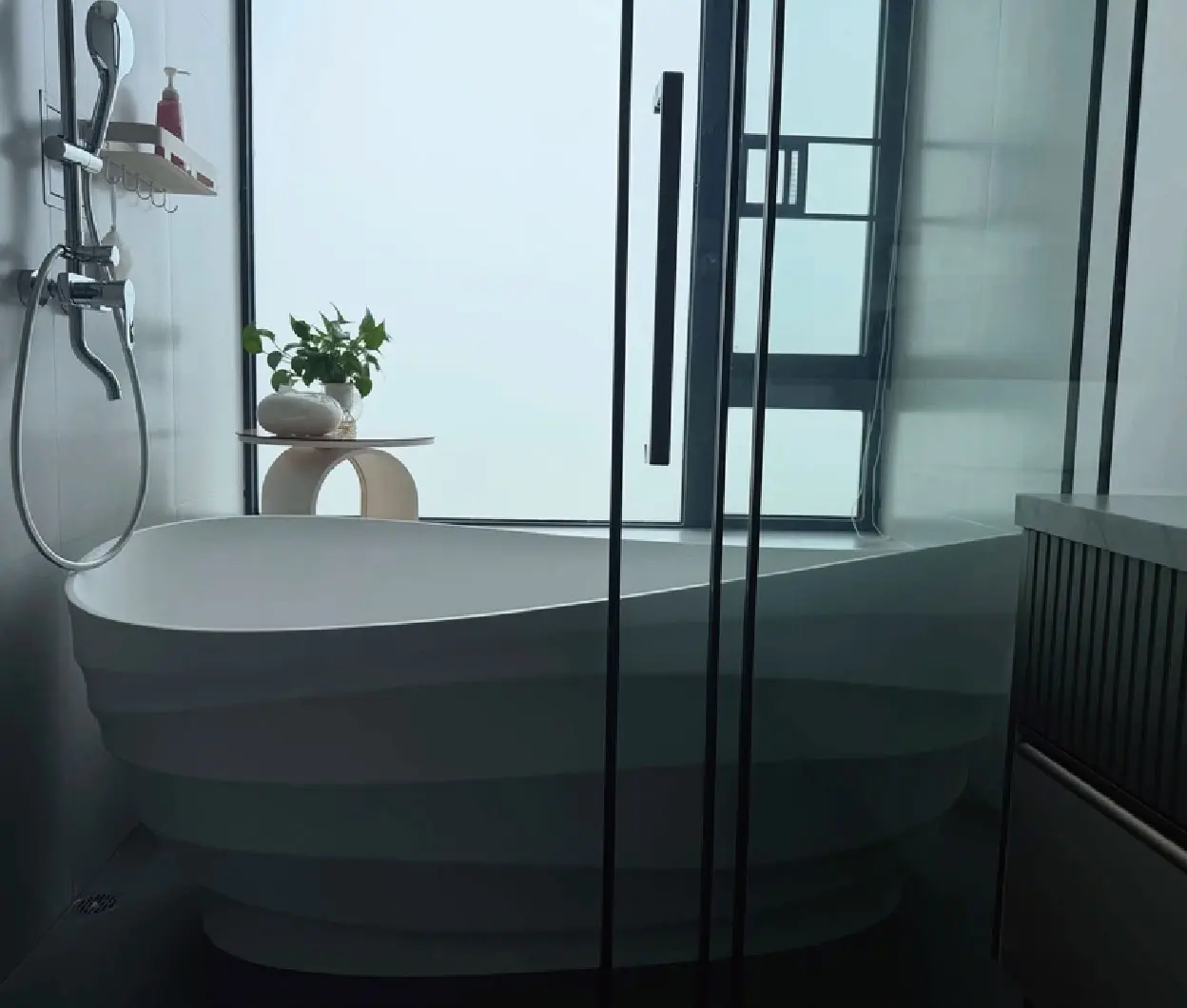White bathtub in a glass shower bathroom
