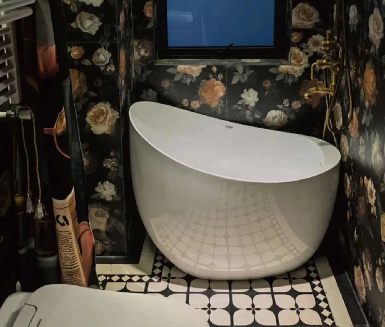 White bathtub in a dark floral bathroom
