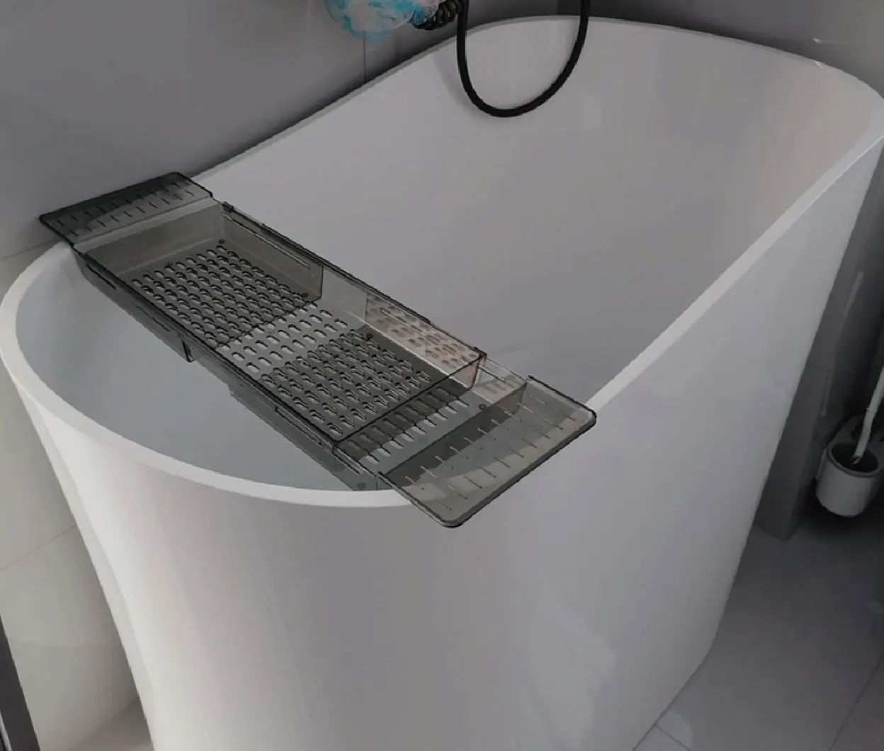 White bathtub detail with bath tray